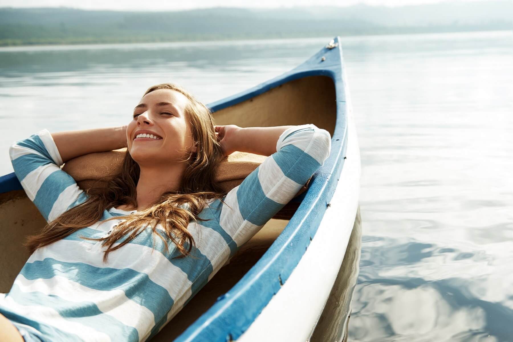 Woman relaxing in a canoe